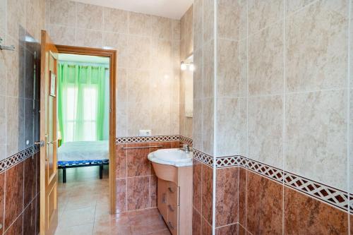 a bathroom with a shower with a sink and a mirror at Chalet Islantilla "Costa de la Luz" in Lepe