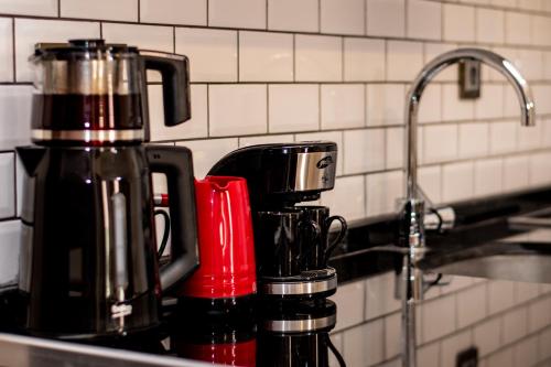 two coffee cups sitting on a counter next to a sink at Fortunella Suites in Finike