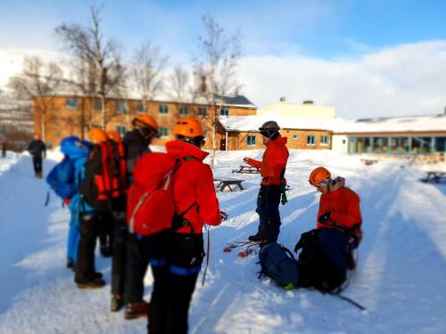 people on skis in the snow at STF Abisko Turiststation in Abisko