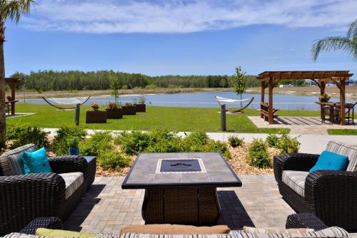 a patio with couches and a table and a lake at Holiday Inn Express & Suites Trinity, an IHG Hotel in Trinity