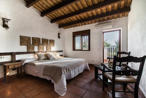 a bedroom with a bed and a table and a chair at El Pueblo de Leo in Badajoz