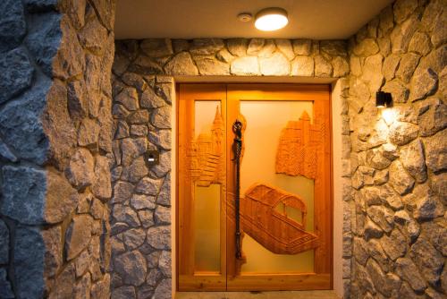 a window in a stone wall with a suitcase on display at Pr Anzl in Bled