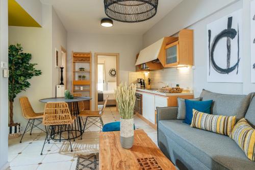 a living room with a couch and a table at Creticum Suites in Heraklio Town