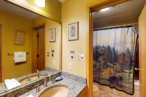 a bathroom with a sink and a shower curtain at Purgatory Village #305 in Durango Mountain Resort