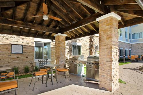 a patio with an outdoor kitchen with a ceiling fan at Staybridge Suites - Houston - Medical Center by IHG in Houston