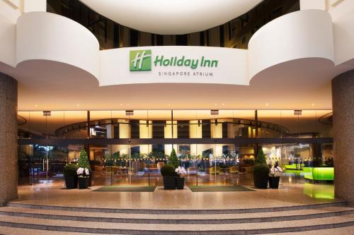 a lobby of a shopping mall with a sign for a holiday inn at Holiday Inn Singapore Atrium by IHG in Singapore