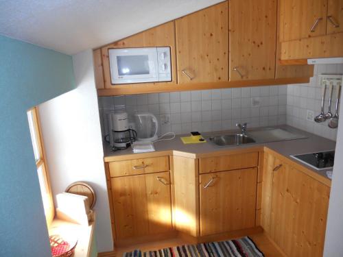a small kitchen with a sink and a microwave at Urblhof in Leutasch