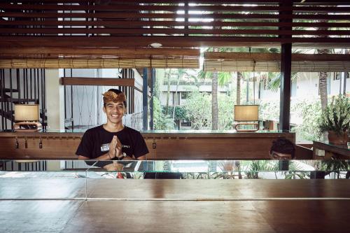 a man standing in front of a table at Outpost Ubud Penestanan in Ubud