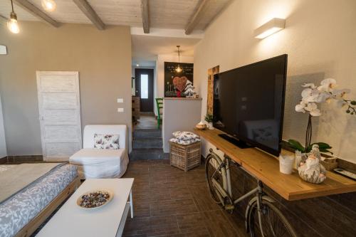 a living room with a large flat screen tv at B&B La Casetta in Aci Bonaccorsi