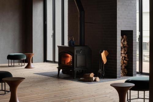 a living room with a fireplace and a stove at Hotel Aoka Kamigoto in Shinkamigoto