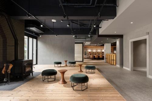 a lobby with chairs and tables and a fireplace at Hotel Aoka Kamigoto in Shinkamigoto