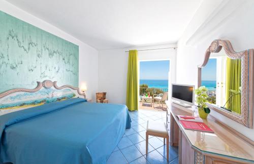 a bedroom with a bed and a view of the ocean at Hotel San Giorgio Terme in Ischia