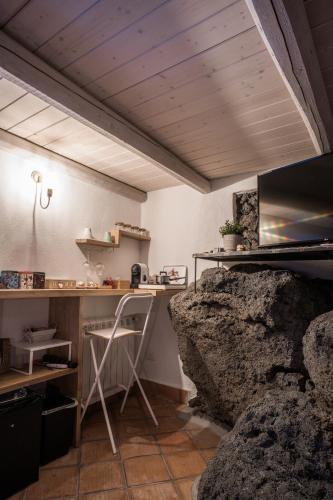 a kitchen with a desk and a rock at B&B La Casetta in Aci Bonaccorsi
