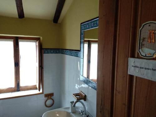 a bathroom with a sink and a mirror at Reitoral de Chandrexa in Parada del Sil