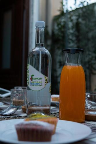 a bottle of orange juice next to a plate of food at B&B La Casetta in Aci Bonaccorsi