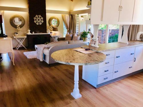 a kitchen with a table in the middle of a room at Retreat in Hillcrest