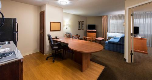 a room with a table and a living room at Candlewood Suites Macon by IHG in Macon