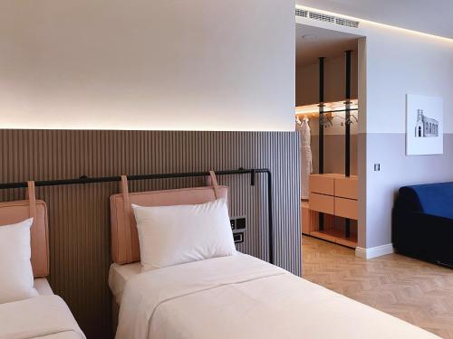 a bedroom with two beds and a closet at Iliria Boutique Hotel in Tirana