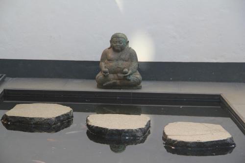 a statue of a woman sitting on a table with four stones at Odense City B&B in Odense
