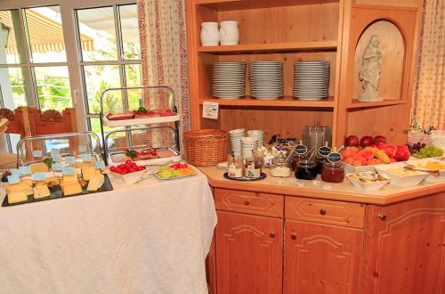a kitchen with a table with food on it at Hotel Garni Malerwinkl in Bad Hindelang