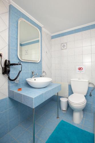 a bathroom with a sink and a toilet and a mirror at Angel-kolymvari4you in Kolymvari