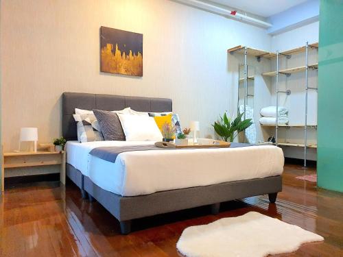 a bedroom with a large bed with a tray on it at The Scott Garden Kuala Lumpur by BeeStay Management in Kuala Lumpur