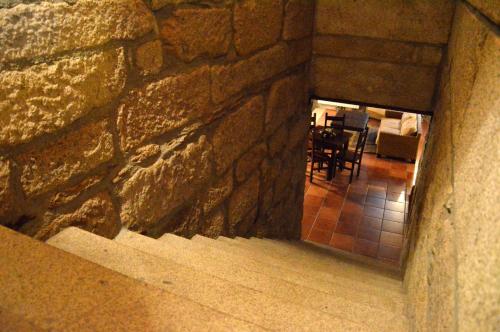 a stone wall with stairs leading to a dining room at Quinta do Olival in Vilas Boas