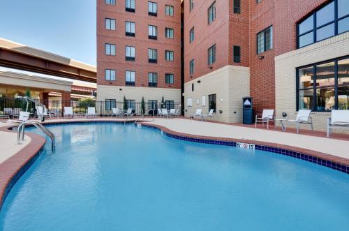 a large swimming pool in front of a building at Staybridge Suites - Oklahoma City - Downtown, an IHG Hotel in Oklahoma City
