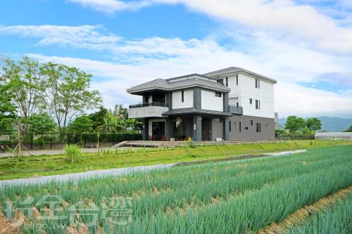 a house in the middle of a field at Chu V B&B in Yuanshan