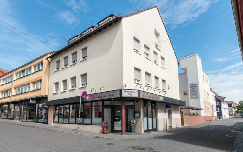 a large white building on a city street at Hotel Kirchhainer Hof in Kirchhain