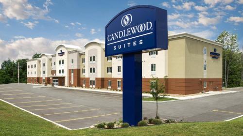 a sign in a parking lot in front of a building at Candlewood Suites Grove City - Outlet Center by IHG in Grove City