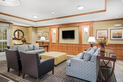 a living room filled with furniture and a fireplace at Candlewood Suites Pittsburgh-Cranberry, an IHG Hotel in Cranberry Township