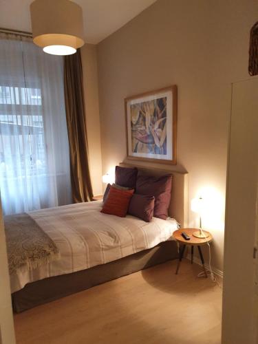 a bedroom with a bed with a table and a window at Studio City West in Berlin