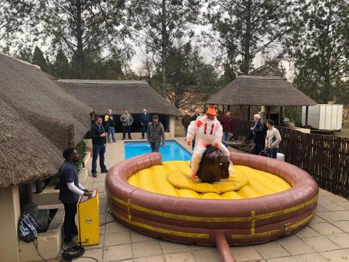 a man sitting on a inflatablelatable at Pine Valley in Lanseria