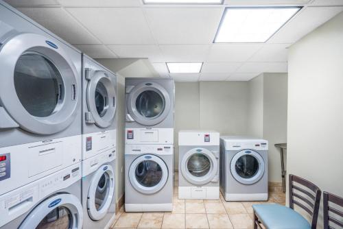 a laundry room with four washers and three washing machines at Staybridge Suites Memphis-Poplar Ave East by IHG in Memphis