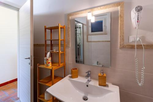 a bathroom with a sink and a mirror at Le Ginestre in Massa