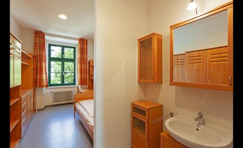 a bathroom with a sink and a mirror at Porzellaneum in Vienna