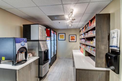 a pharmacy aisle with a coffee machine and a coffee shop at Candlewood Suites Richmond - West Broad by IHG in Richmond