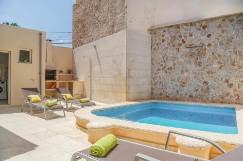 a swimming pool in the middle of a patio at Holiday Home Ribot in Ariany