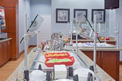 a kitchen with a buffet with food on a counter at Staybridge Suites Houston Stafford - Sugar Land by IHG in Stafford