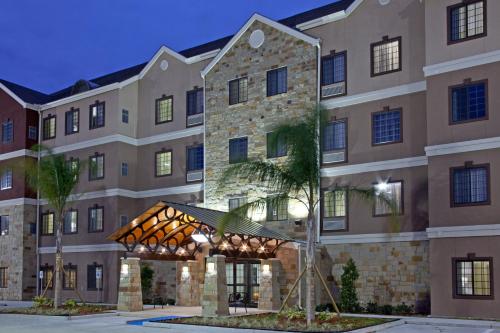 an exterior view of a hotel with a building at Staybridge Suites Houston Stafford - Sugar Land by IHG in Stafford