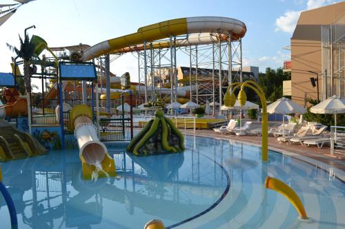 a large swimming pool with a roller coaster at AQI Pegasos World in Side