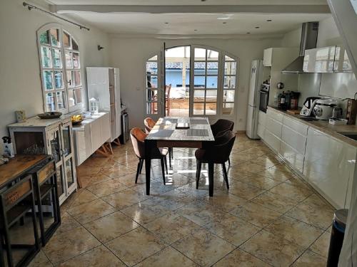 une cuisine et une salle à manger avec une table et des chaises dans l'établissement VILLA FLEUR DES PINS 6 PERSONNES 140m2 PETIT NICE, à Gujan-Mestras