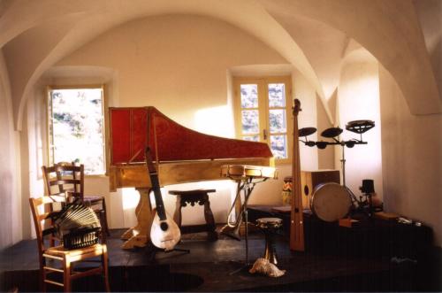 a room with a piano and other musical instruments at Casa Musicale in Pigna