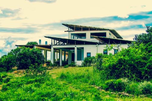 a house on a hill with green grass at Sky Island Resort in Ponta Malongane