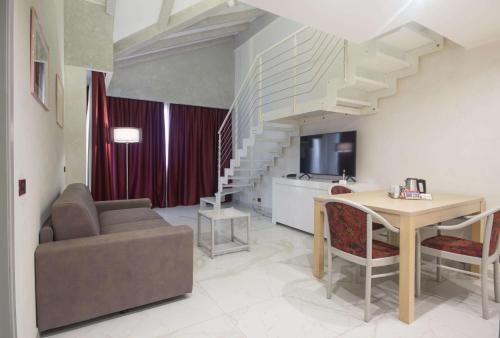 a living room with a couch and a table at Best Western Modena District in Campogalliano