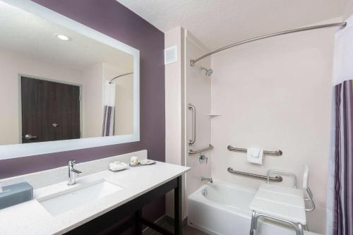 a bathroom with a sink and a tub and a mirror at La Quinta by Wyndham Kanab in Kanab