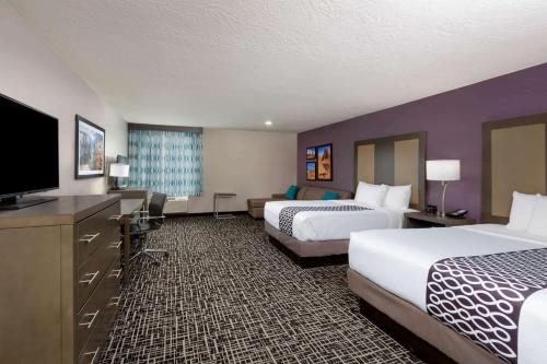 a hotel room with two beds and a flat screen tv at La Quinta by Wyndham Kanab in Kanab