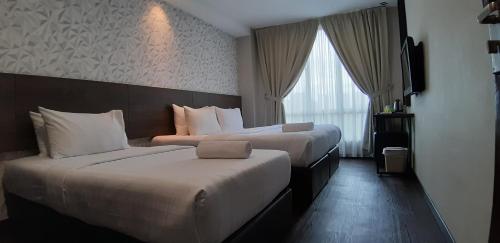 Ένα ή περισσότερα κρεβάτια σε δωμάτιο στο MIICO Hotel @ Mount Austin