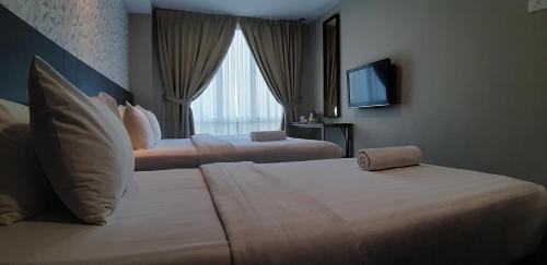 Säng eller sängar i ett rum på MIICO Hotel @ Mount Austin